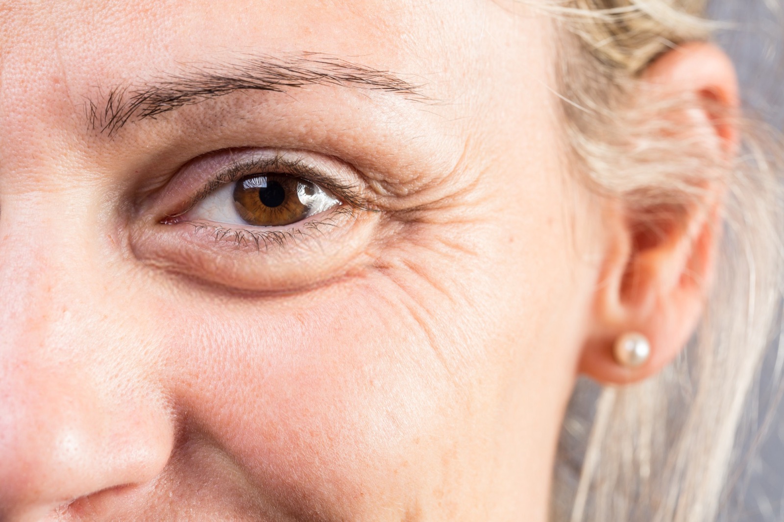 Close-up of a woman's eye with fine lines at the outer corner